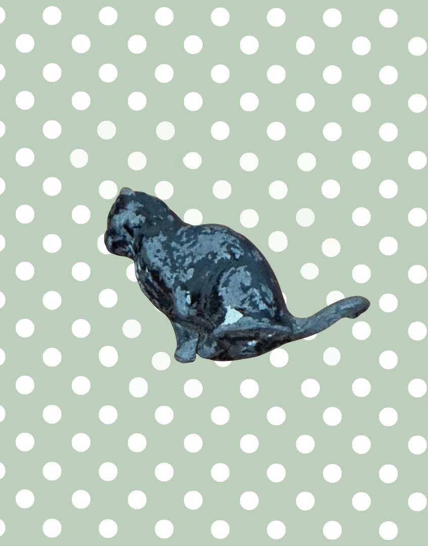 side view of lead metal black cat figurine paint patina