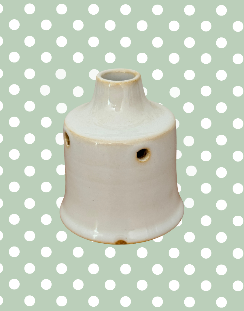 Alternative profile of vintage white glazed pie vent showing vent holes.