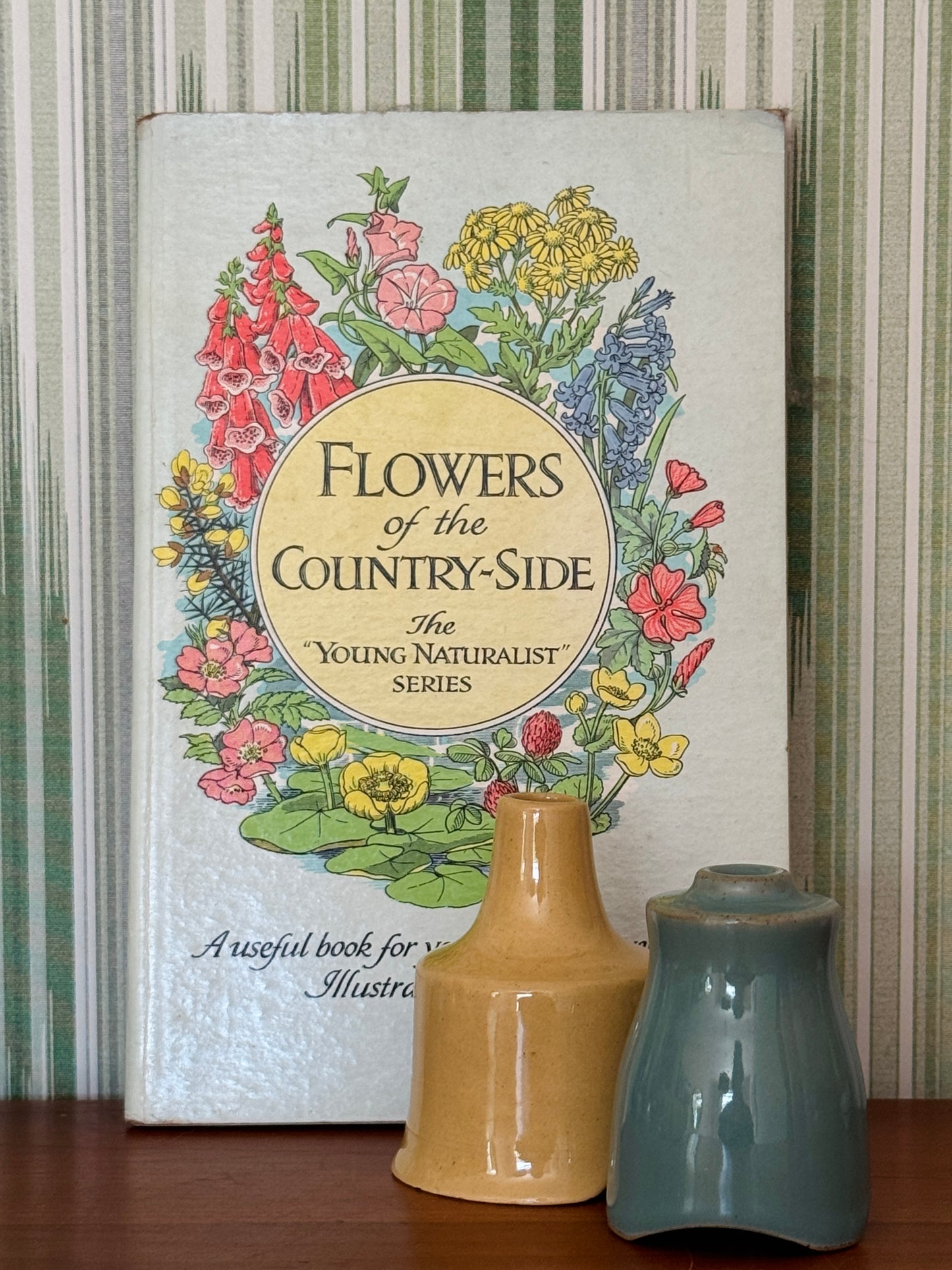 Grandma chic styling of pretty vintage flower book with green and yellow vintage pie vent baking tools.