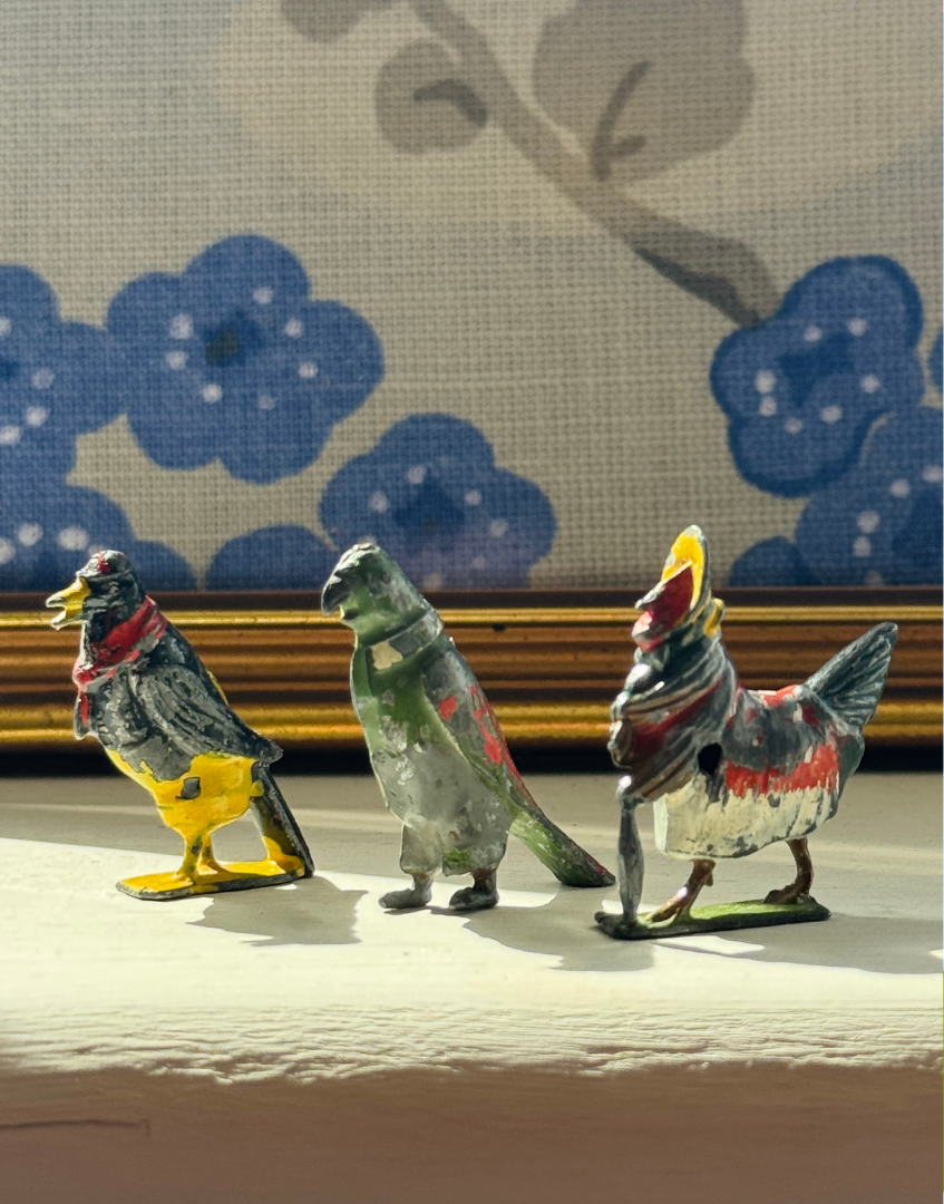 Three vintage Cadbury Cococubs dating from the 1930s, highlighting the fascinating history of Britains lead toys and Cadbury advertising.

