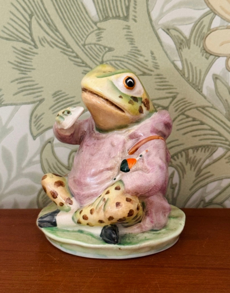 Side view of Beswick Jeremy Fisher figurine holding and eating a sandwich, with beautifully hand-painted coat and character details