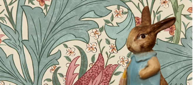 Illustration of a rabbit in a blue dress among floral and leaf patterns