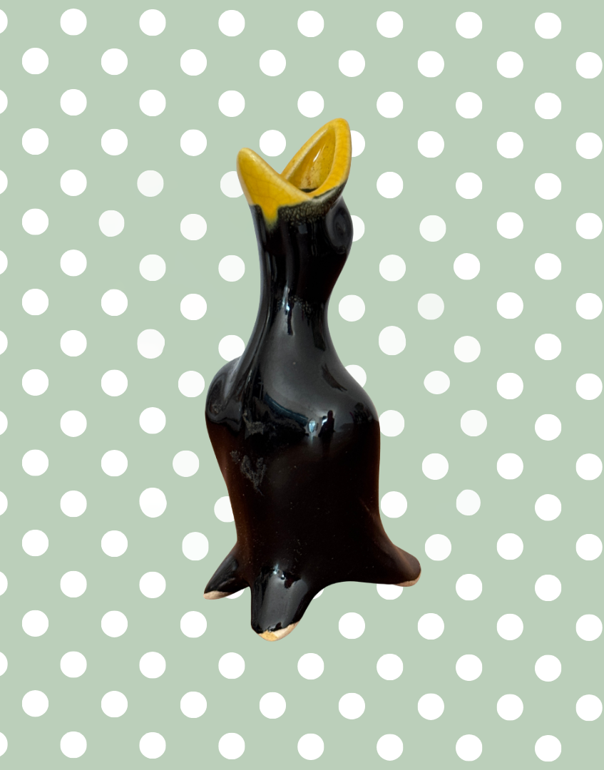 classic 1950s black and yellow pie bird with open mouth