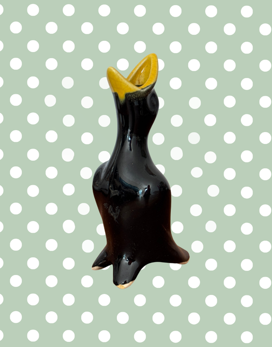classic 1950s black and yellow pie bird with open mouth