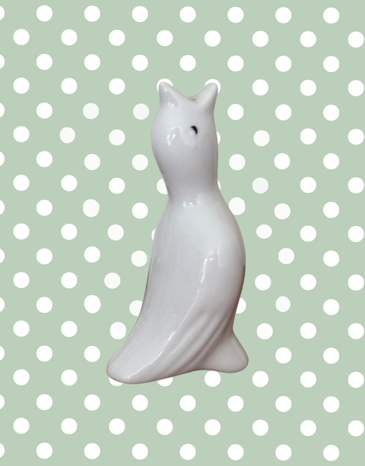 A vintage white ceramic pie bird with detailed wings.