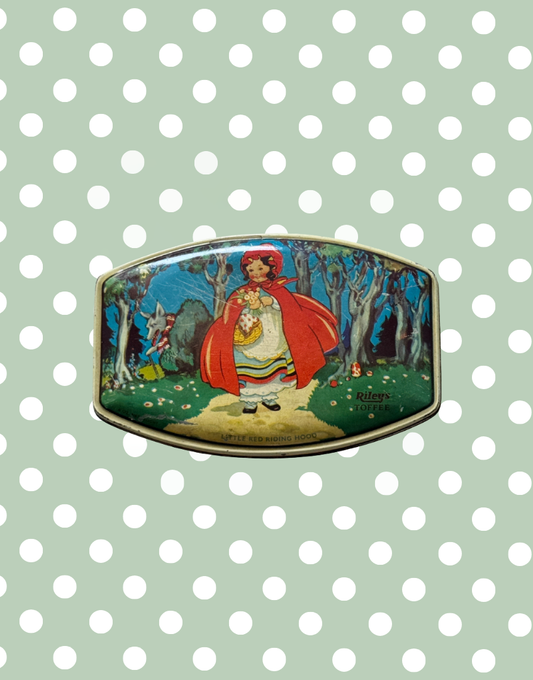 Top view of 1930s Rileys Toffee tin featuring Little Red Riding Hood walking through woodland with wolf illustration and mushroom detail