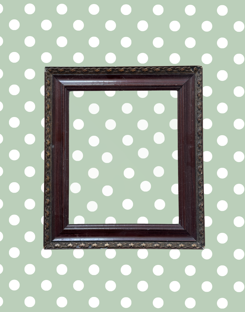 Antique decorative dark wood and metal picture frame with aged detailing and empty aperture.