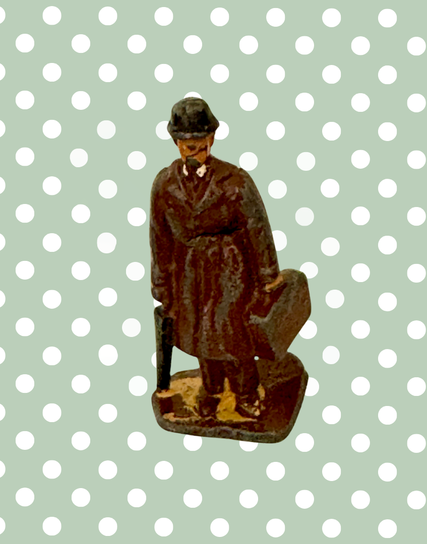 vintage lead figurine of commuter gentleman with bowler hat, trench coat, suitcase and umbrella 1930s