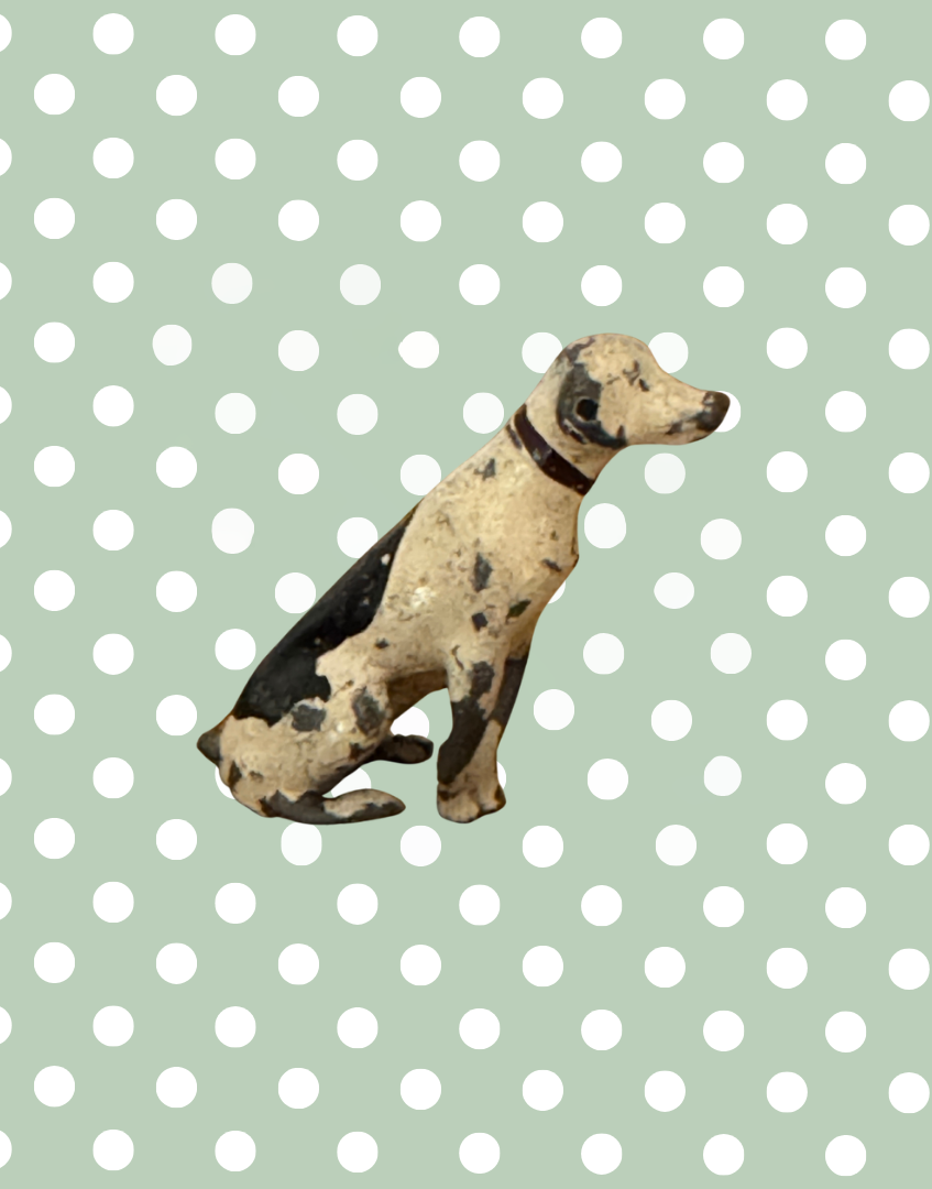 Rear side view of sitting black and white spotted Britains dog with black 