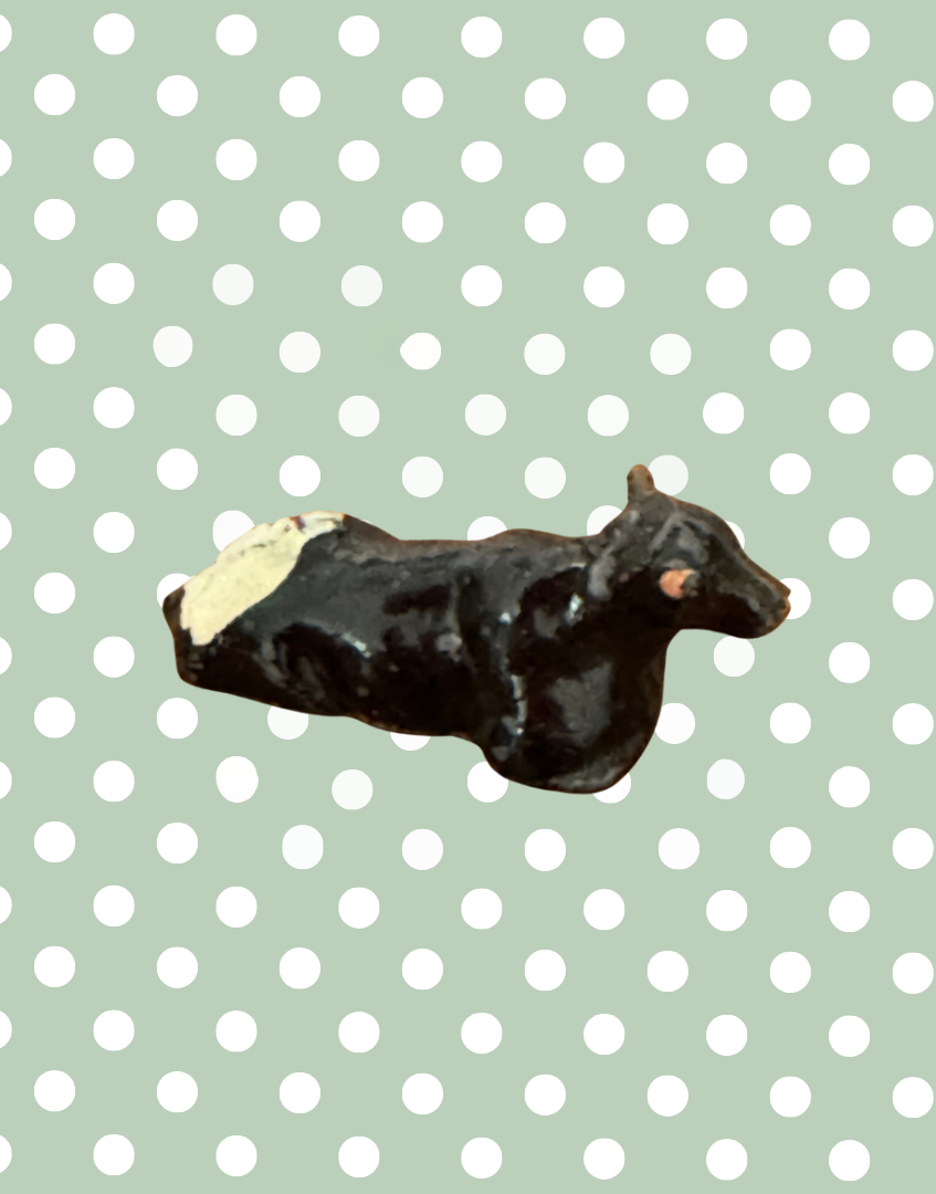 miniature lying black, white and pink hand painted lead figurine