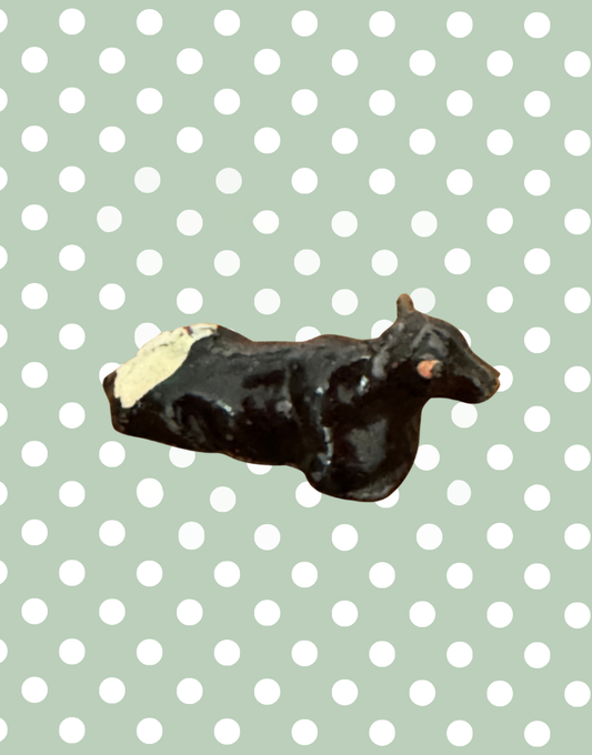 miniature lying black, white and pink hand painted lead figurine