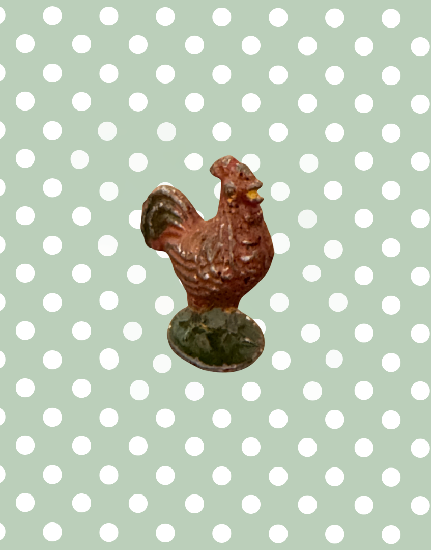 brown rooster lead figurine on green stand