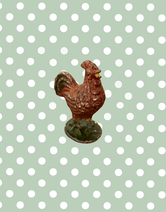 brown rooster lead figurine on green stand