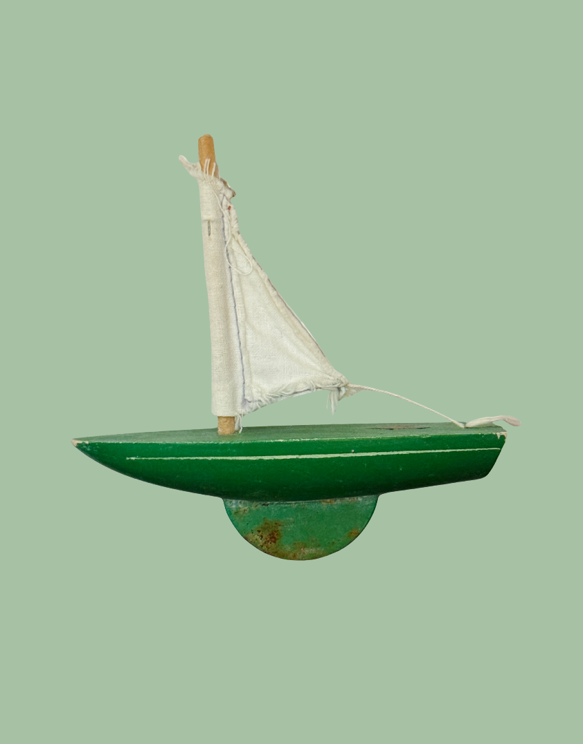 Vintage Star Yachts No. 0 green wooden pond yacht with white sail and original painted finish.