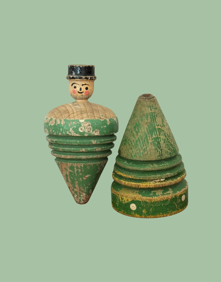 Pair of antique early 20th century wooden spinning tops, including a hand carved gentleman and a painted polka dot top.