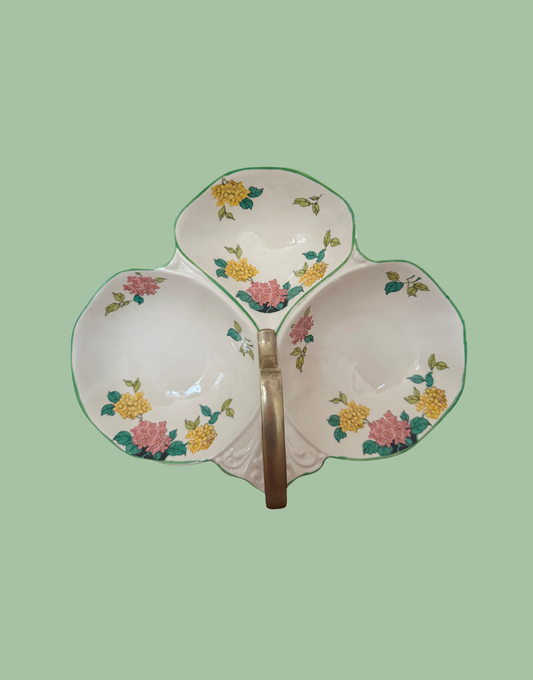 A Flosmaron three-bowl ceramic serving platter with a central handle, decorated with a floral pattern in pink, yellow, and green on a white background.