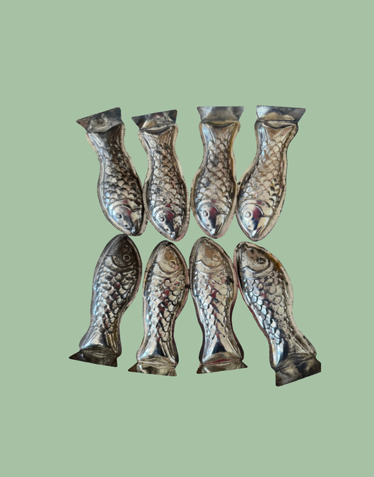 Collection of eight vintage fish shaped tinplate moulds from a set of ten European kitchenalia collectables
