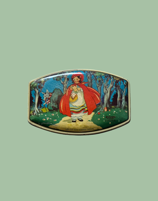 Top view of 1930s Rileys Toffee tin featuring Little Red Riding Hood walking through woodland with wolf illustration and mushroom detail