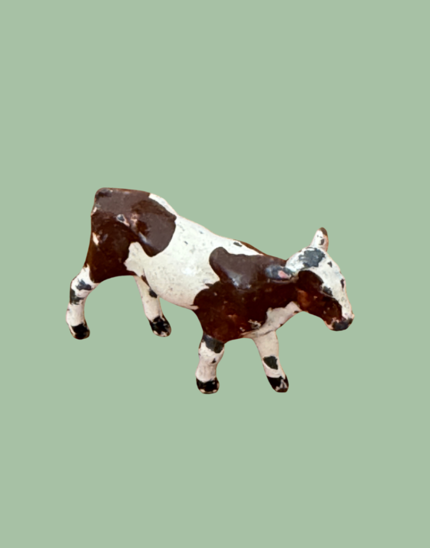brown and white patched miniature calf lead figurine