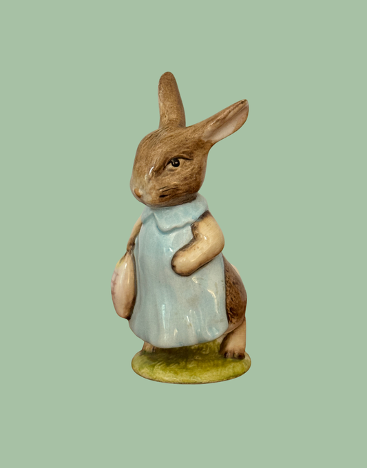 Vintage Beswick Mrs Flopsy Bunny Beatrix Potter figurine in blue clothing on a green base.