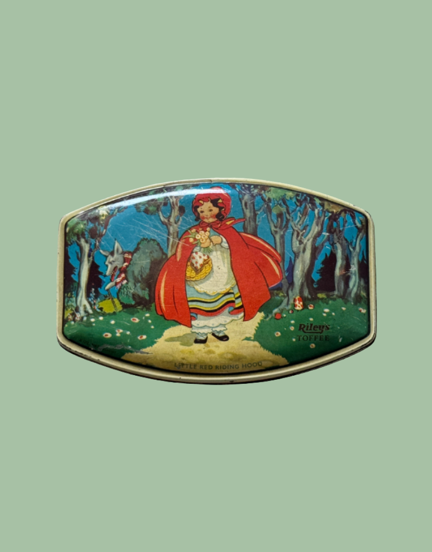 Top view of 1930s Rileys Toffee tin featuring Little Red Riding Hood walking through woodland with wolf illustration and mushroom detail