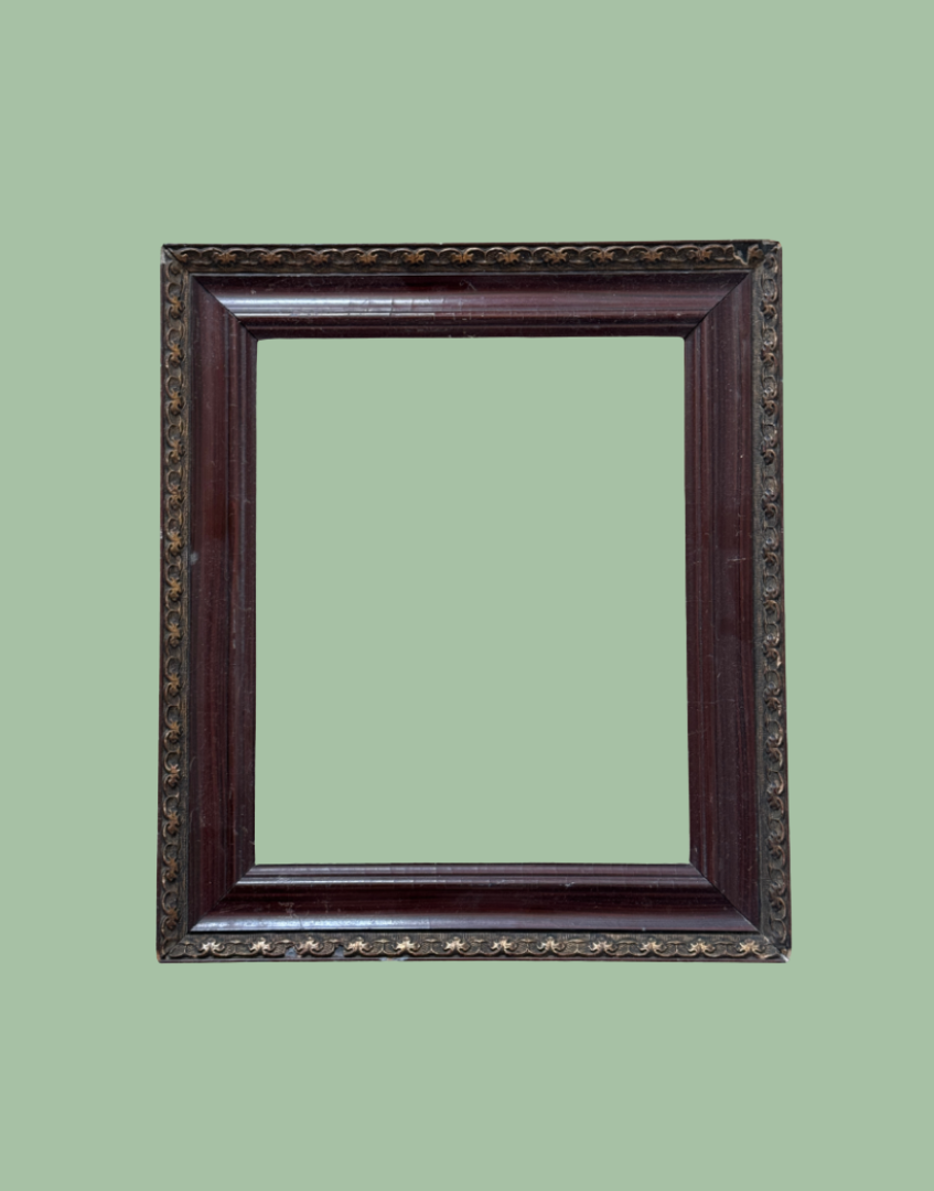 An ornate rectangular picture frame with a dark reddish-brown wood finish and gold star details, shown against a solid sage green background.