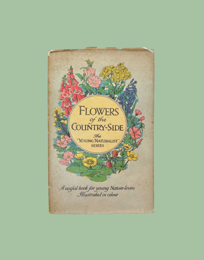 Vintage book titled 'Flowers of the Country-Side' from The Young Naturalist Series, featuring a colorful floral illustration on a beige cover, set against a solid sage green background.