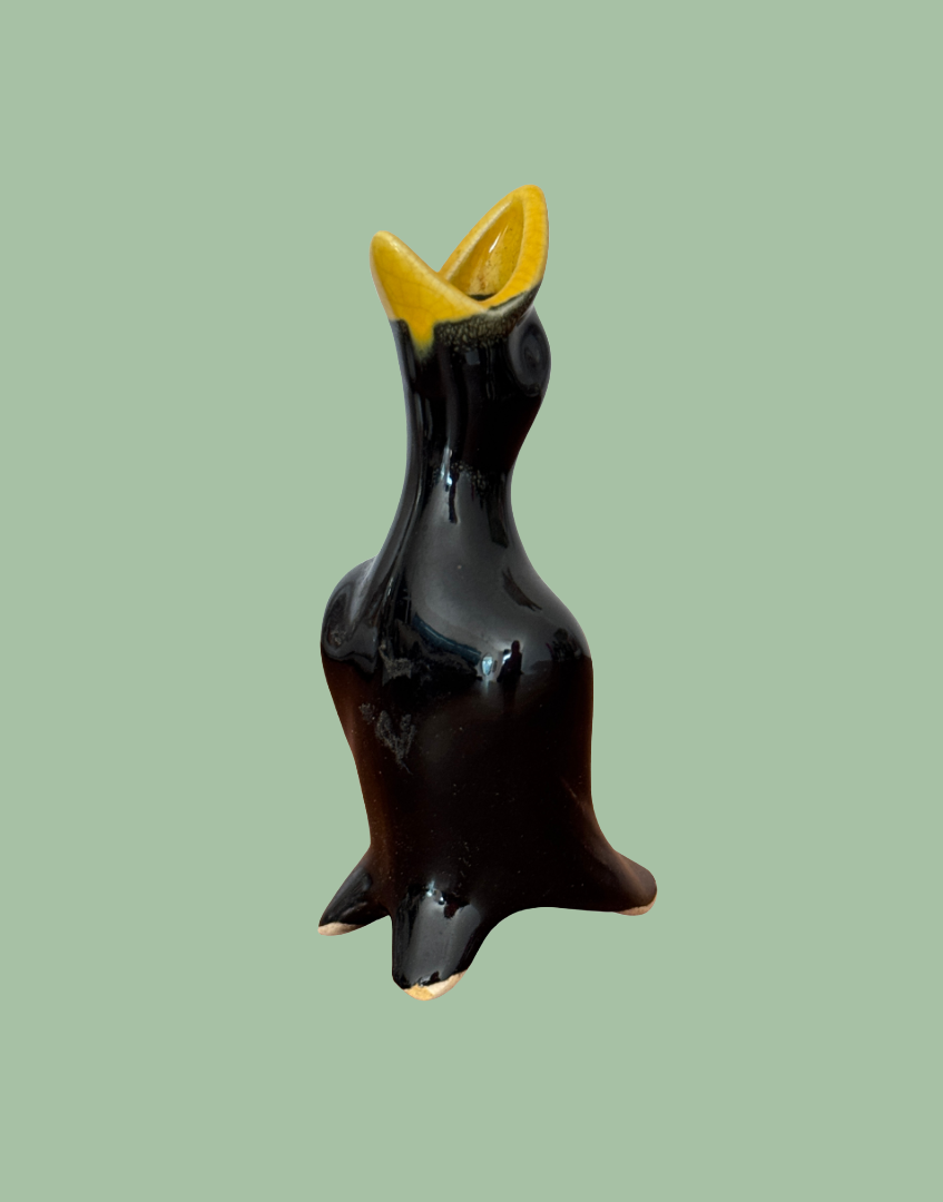classic 1950s black and yellow pie bird with open mouth