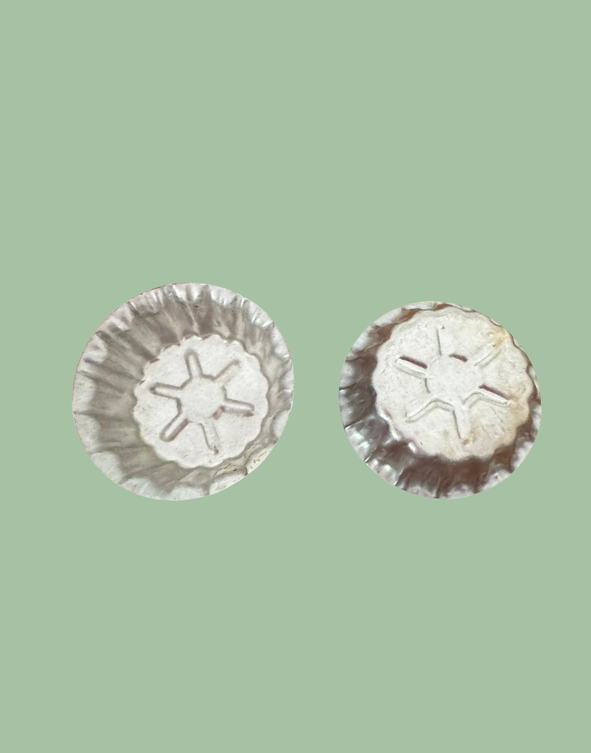 Vintage aluminium star mould showing front fluted design and reverse embossed star detail from a European kitchenalia collection