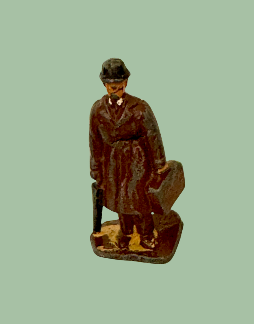 vintage lead figurine of commuter gentleman with bowler hat, trench coat, suitcase and umbrella 1930s