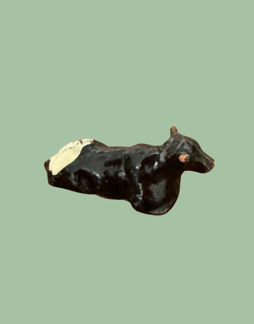 miniature lying black, white and pink hand painted lead figurine