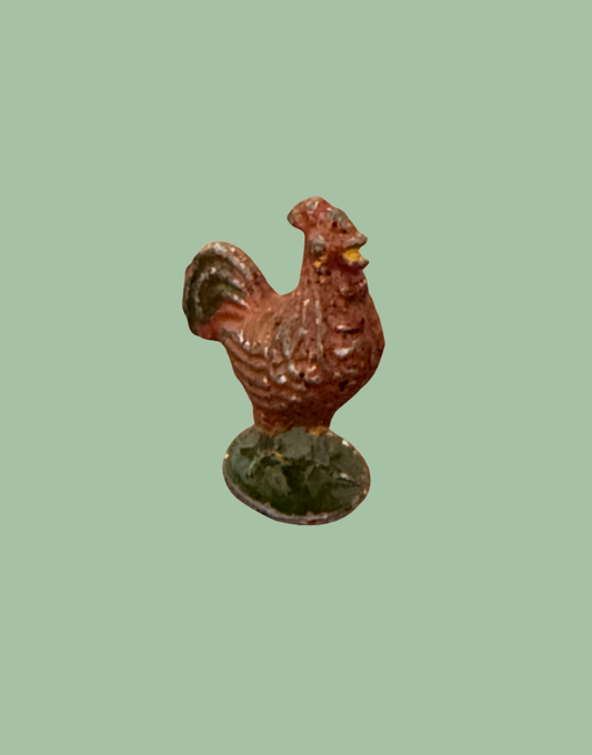 brown rooster lead figurine on green stand