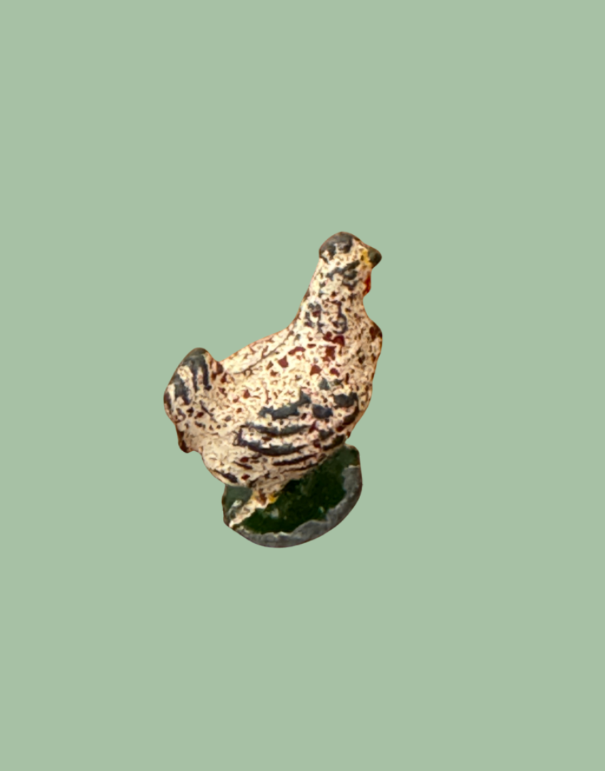 Small britains chicken lead figurine on a polka dot background