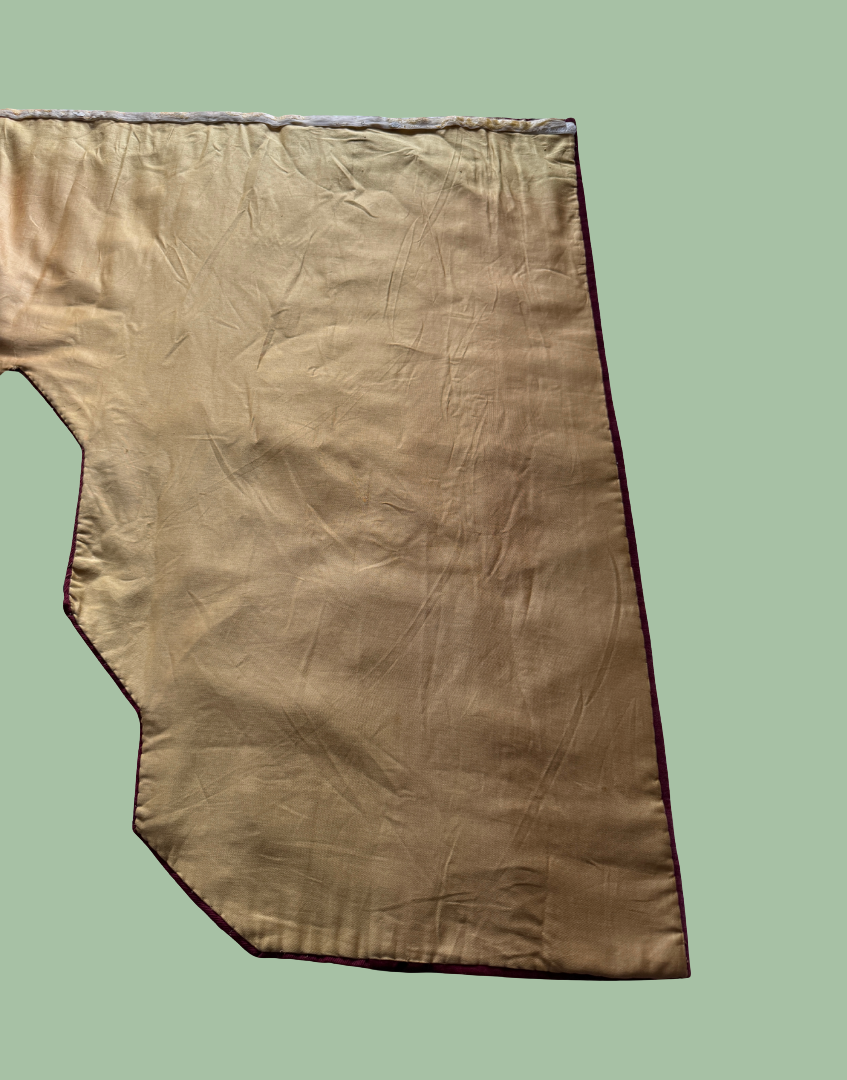 Reverse middle section of the antique pelmet showing the protective lining and construction behind the original embroidery.