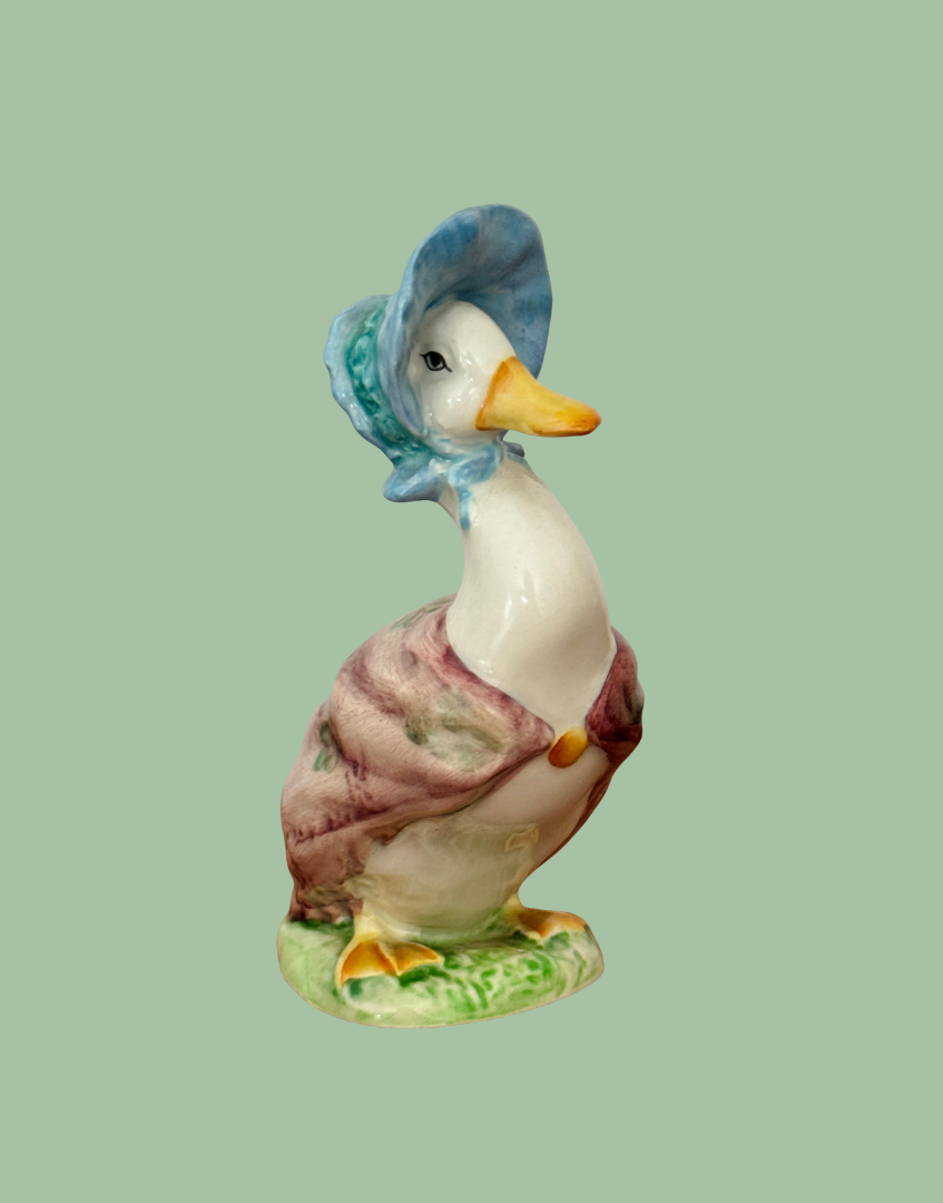Side view of vintage Beswick Jemima Puddle Duck figurine showing bonnet and shawl detail