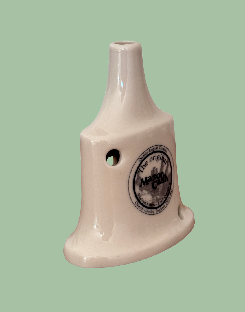 Side front view of white ceramic Mason Cash 'The Traditional' pie vent with blue makers stamp