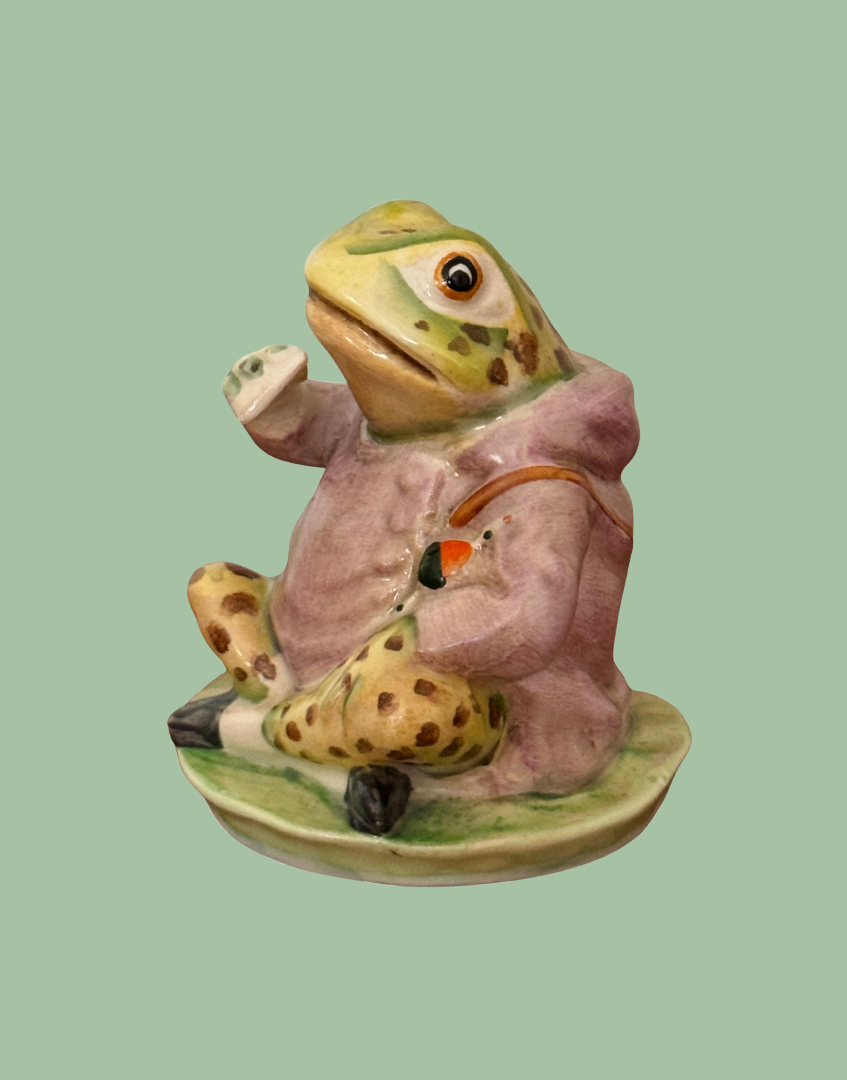 Side view of Beswick Jeremy Fisher figurine holding and eating a sandwich, with beautifully hand-painted coat and character details