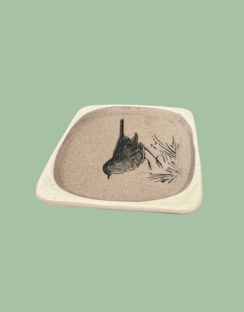 Top side view of beige glasec ceramic bird dish