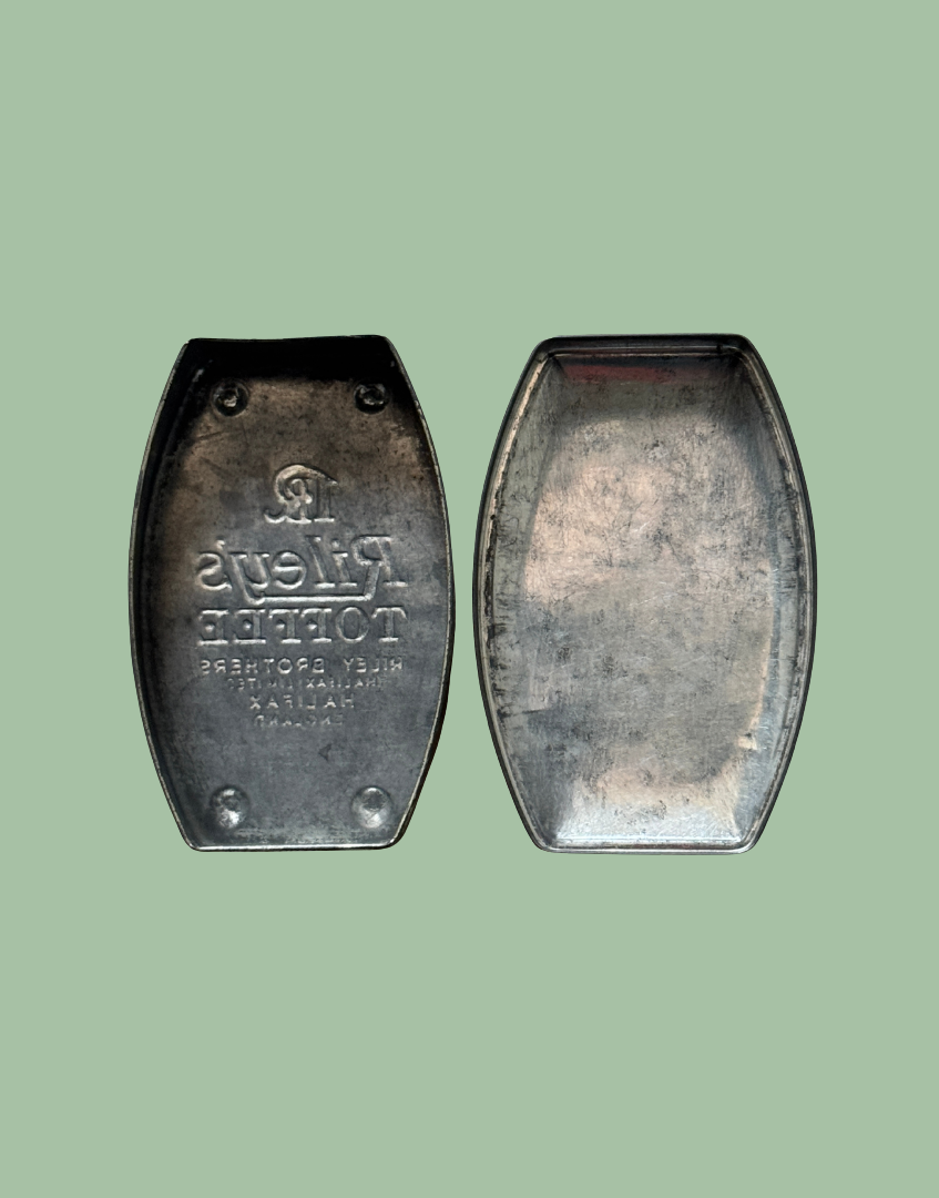 Interior view of vintage Rileys Toffee tin showing inside of tin and underside of lid with aged metal finish and original construction