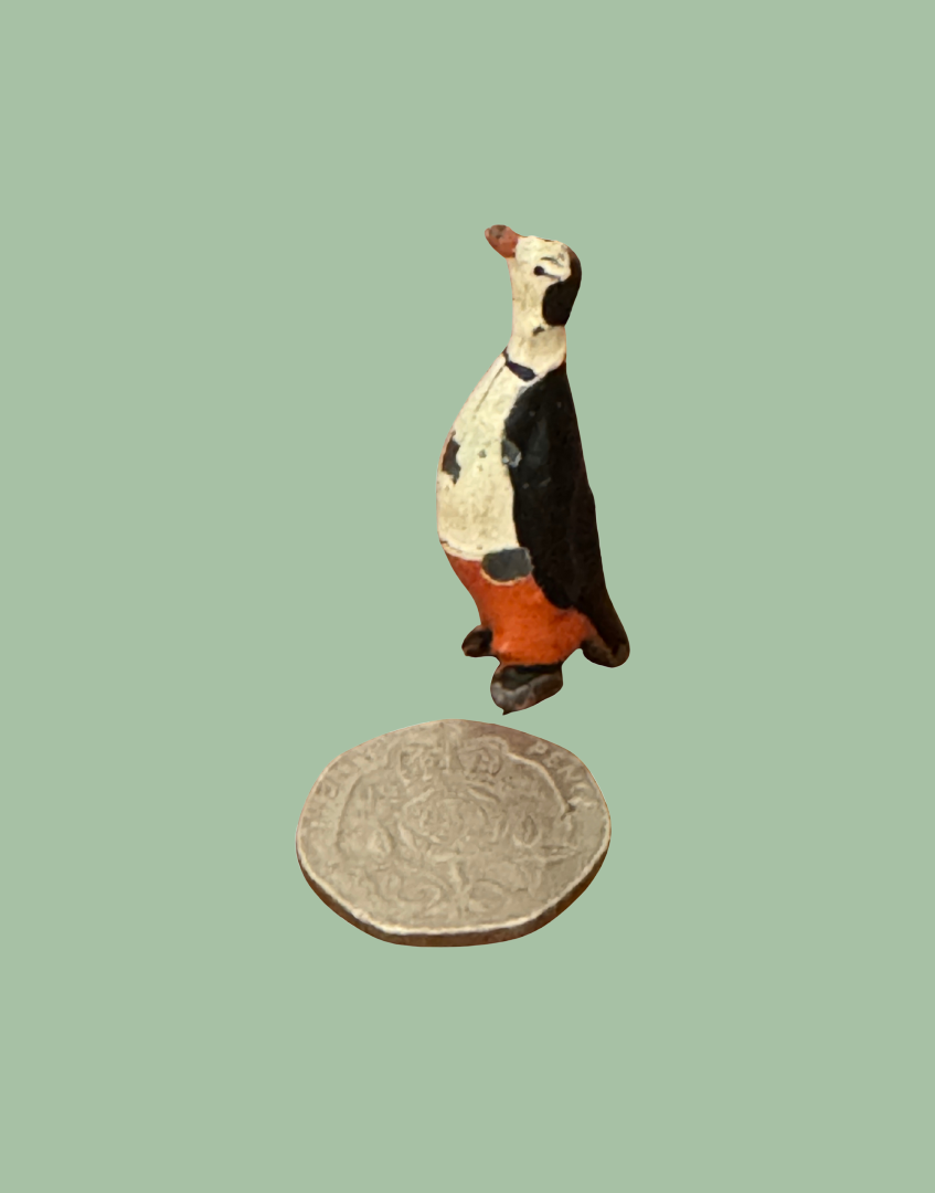 pete penguin miniature cadbury cococub collectible next to twenty pence coin to show scale