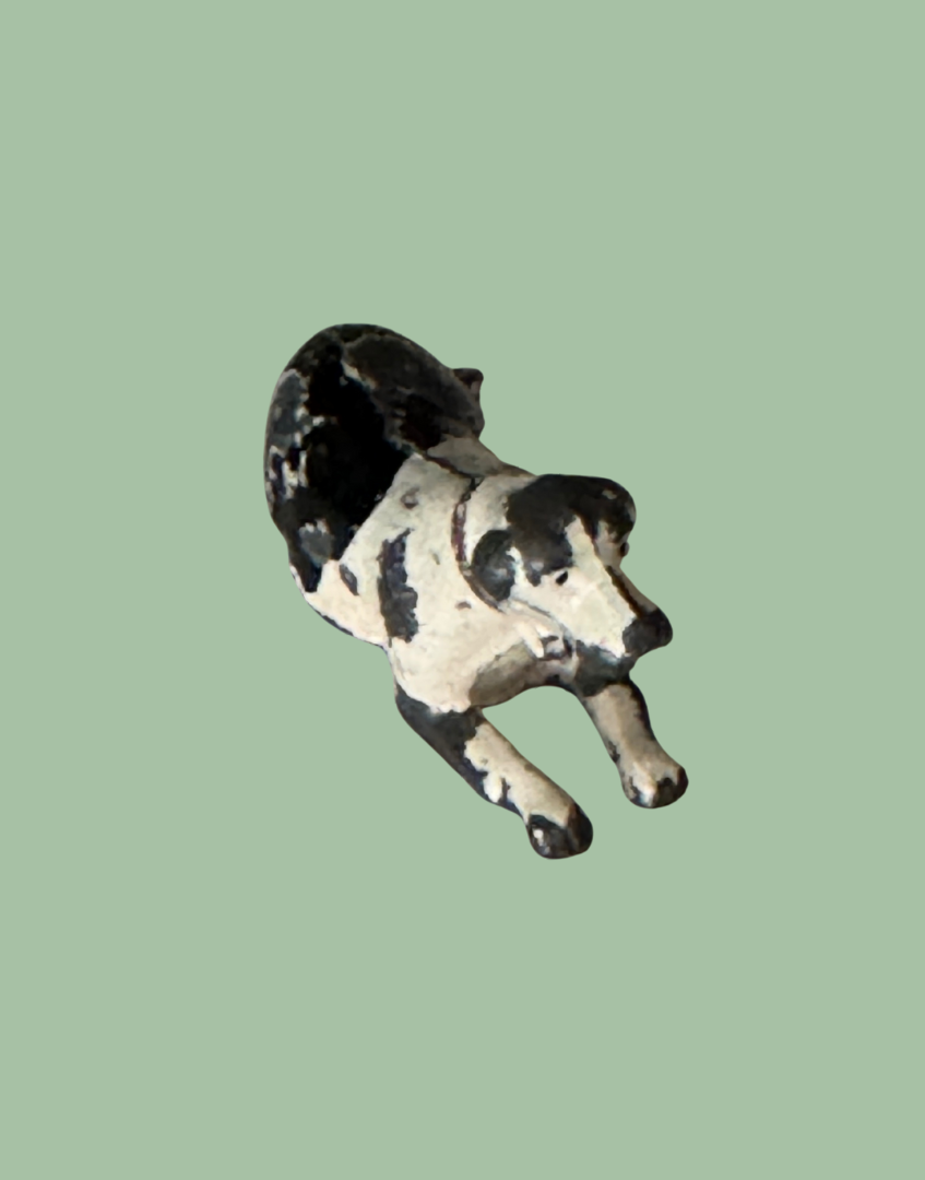 Small hollow cast black and white dog intage toy collectable