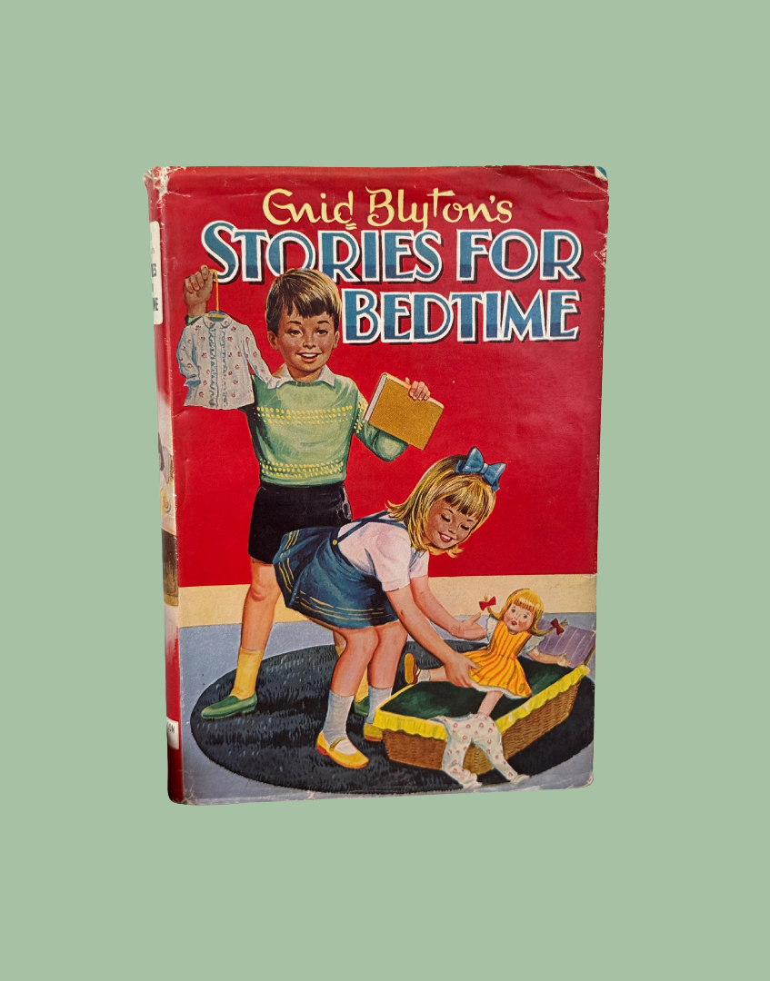 A vintage hardcover book titled 'Enid Blyton's Stories for Bedtime' featuring a red cover with colorful retro illustrations of children and a doll, set against a solid sage green background.