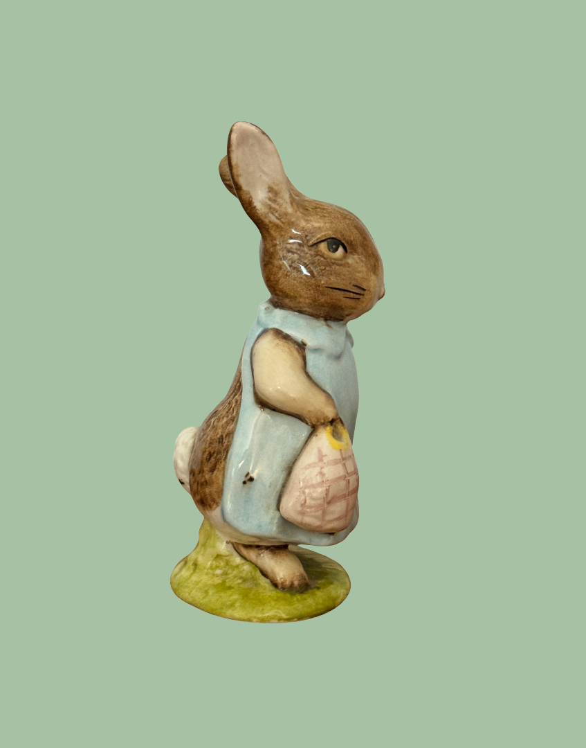 Side view of vintage Beswick Mrs Flopsy Bunny showing her blue clothing and handbag