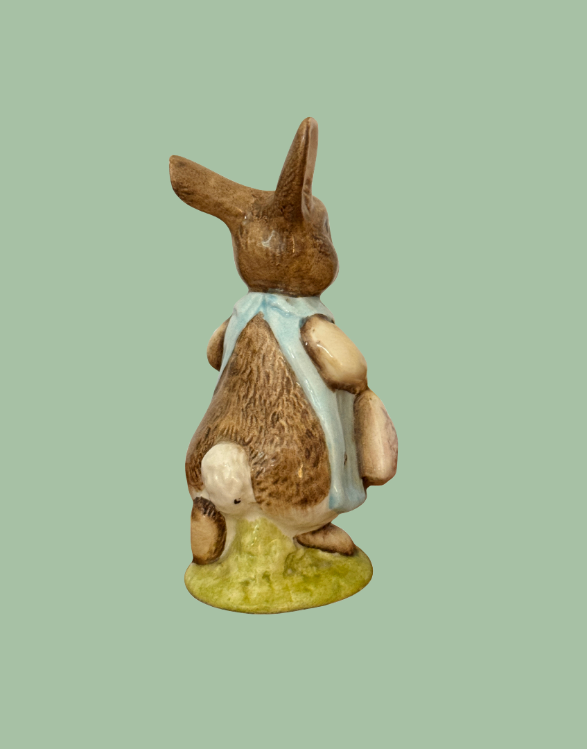 Right rear view of Beswick Mrs Flopsy Bunny showing her white tail and blue clothing.