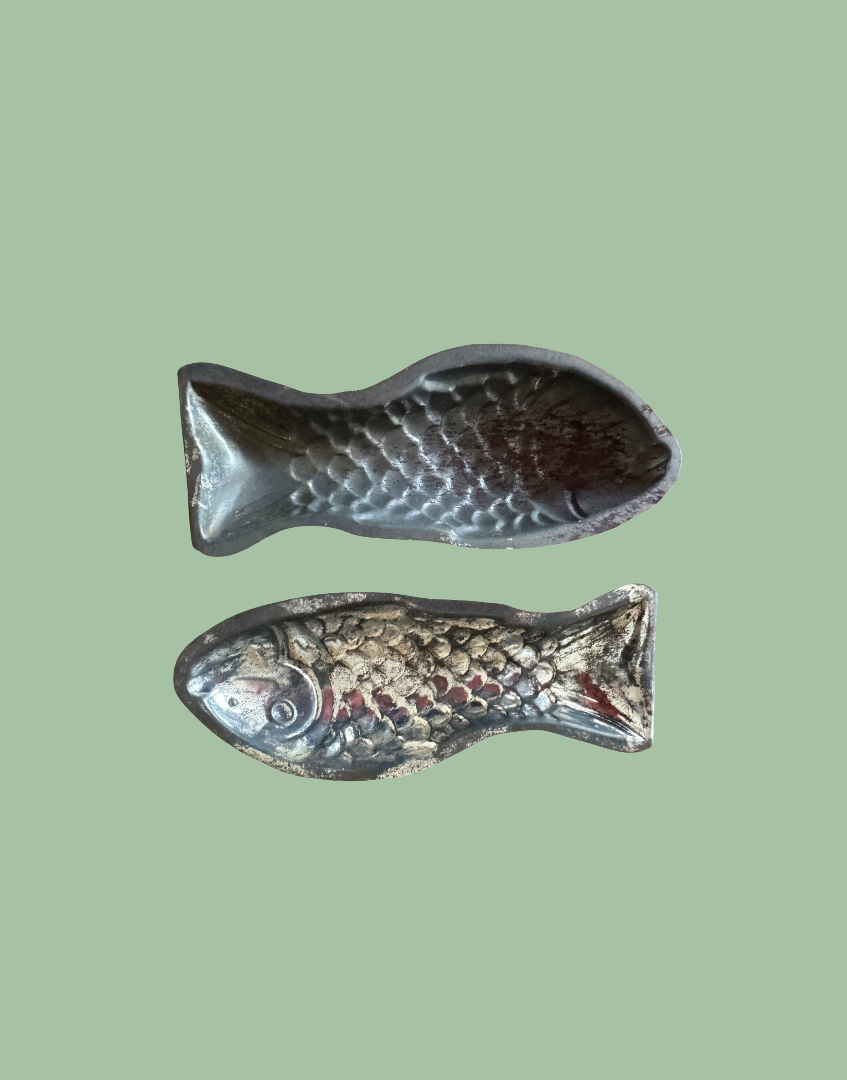 Top view of the remaining two vintage fish shaped tinplate moulds showing detailed form and silver toned finish
