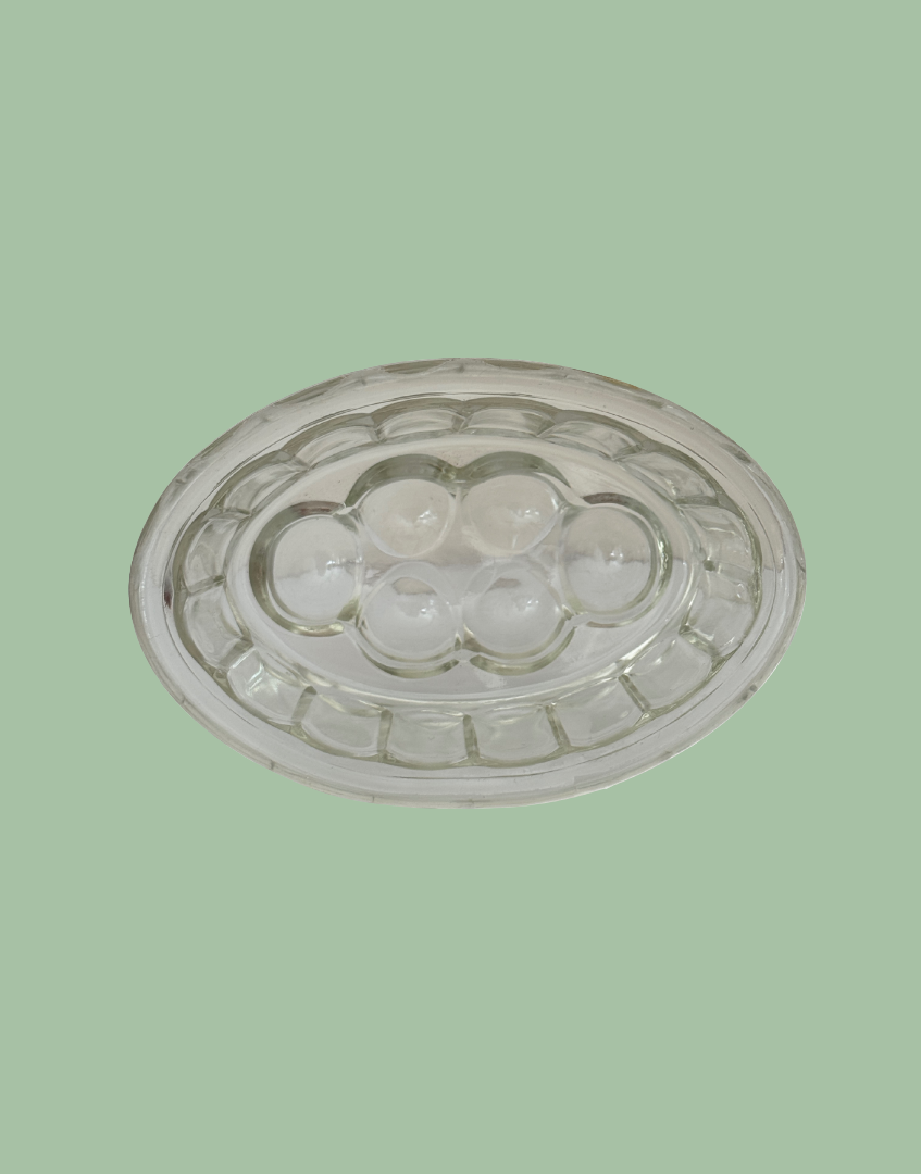 Underside view of small vintage pressed glass jelly mould