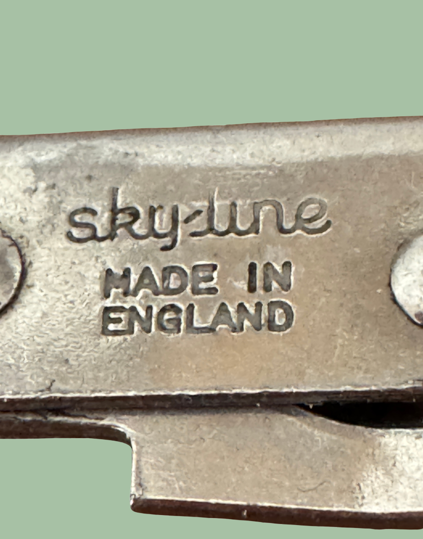 Close up of multifunctional kitchen opener with 'sky-line MADE IN ENGLAND' engraving