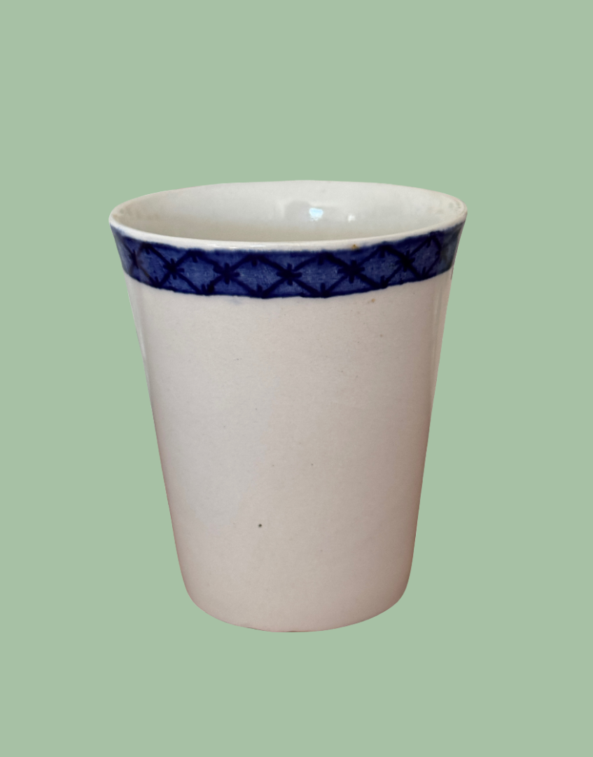 Reverse side view of white and blue antique Staffordshire Collectable cup