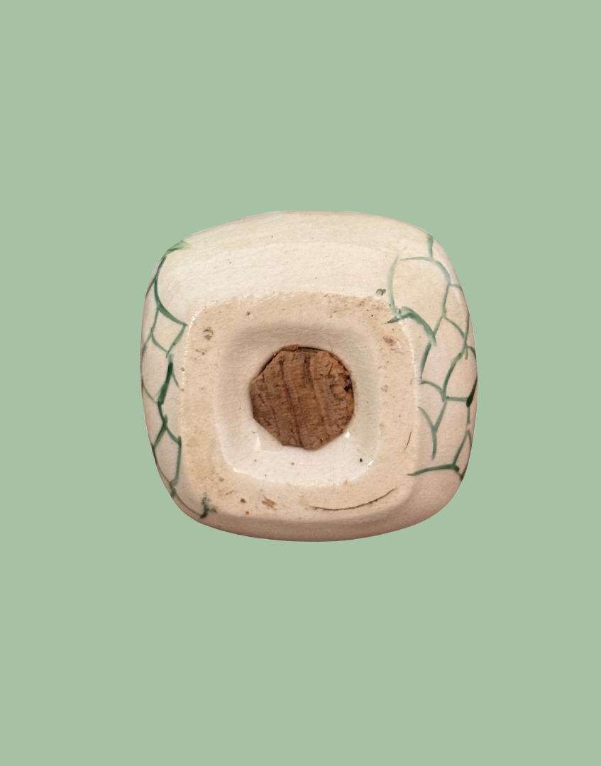 Base of miniature pepper pot kitchen collectable showing cork bung.