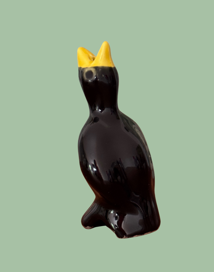 Traditional black and yellow glossy vintage classic pie bird baking tool with characterful eyes